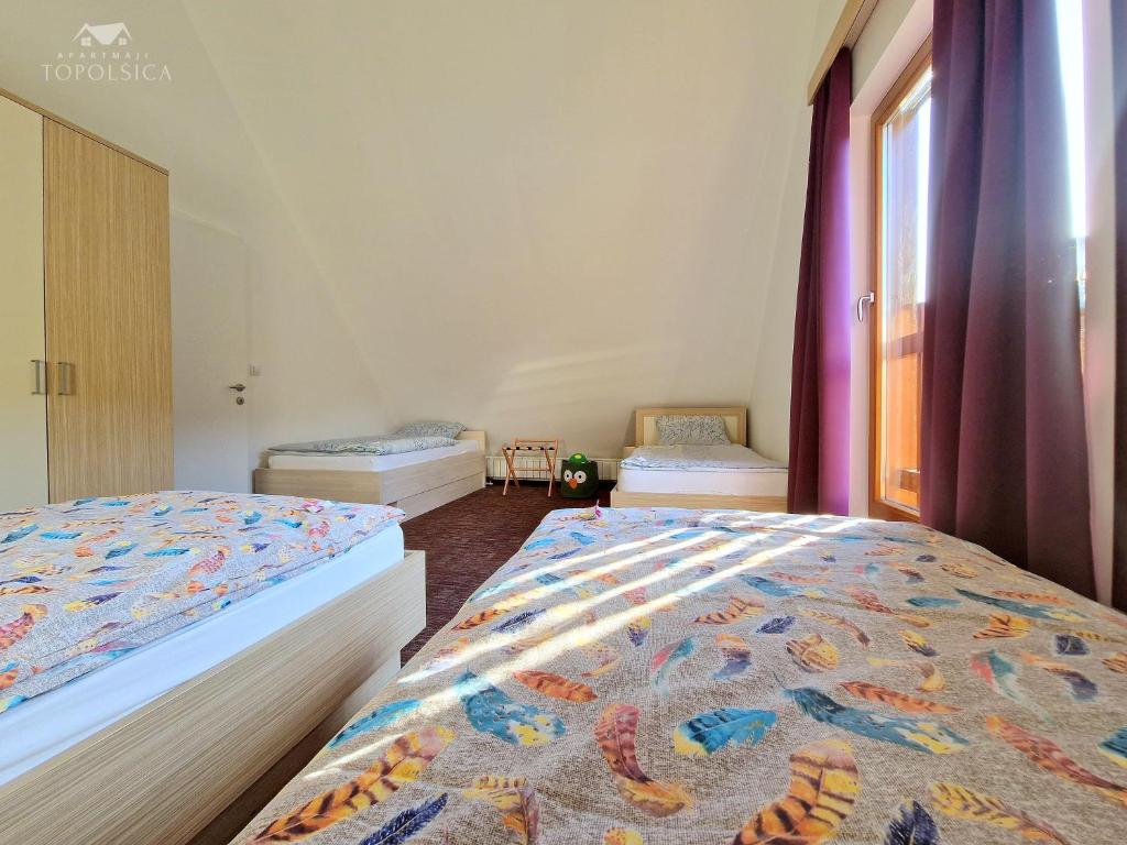 Postel nebo postele na pokoji v ubytování Apartment HORTENZIJA near Terme Topolšica