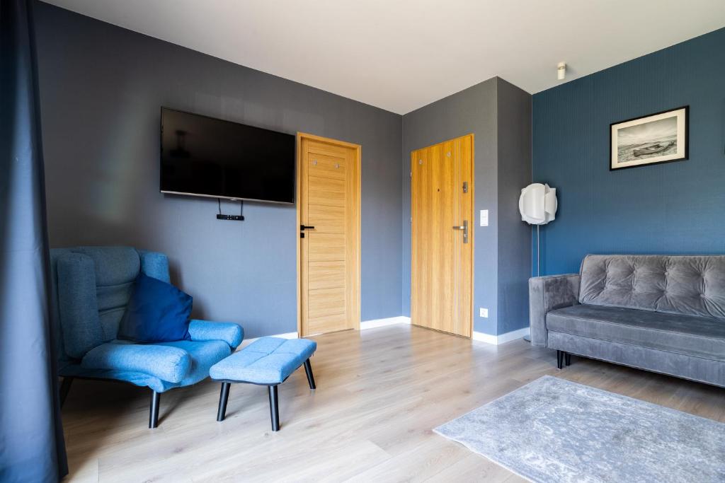 Televízia a/alebo spoločenská miestnosť v ubytovaní Apartamenty Cisza & Spoko! - ACCO RENT
