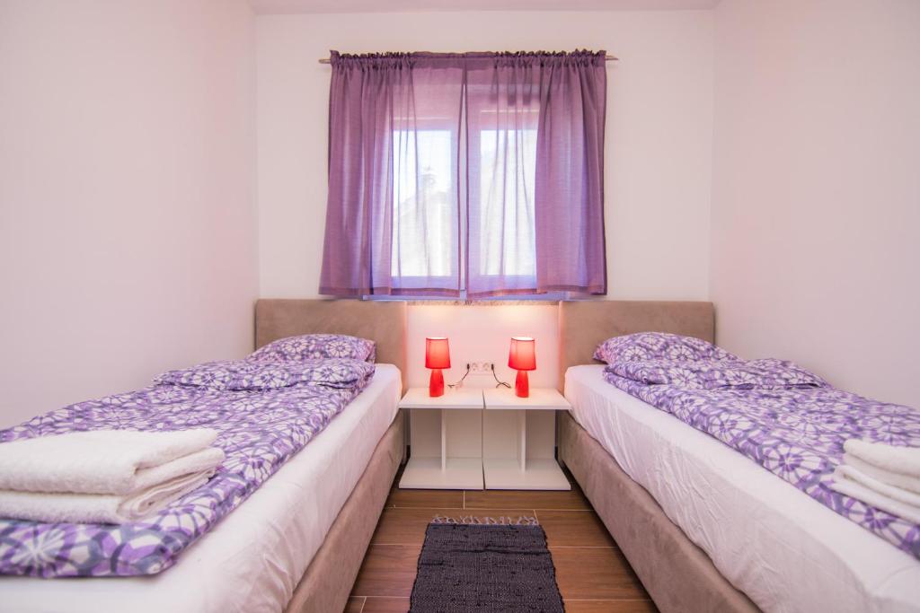 Postel nebo postele na pokoji v ubytování Apartmani Mario