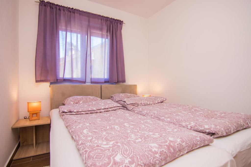Postel nebo postele na pokoji v ubytování Apartmani Mario