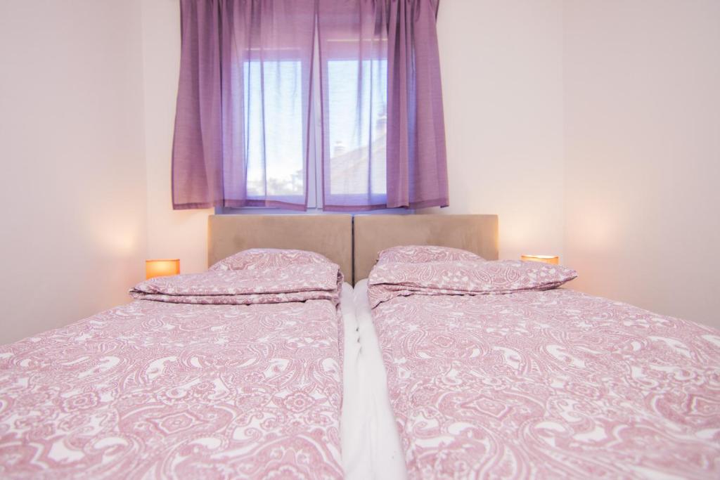 Postel nebo postele na pokoji v ubytování Apartmani Mario