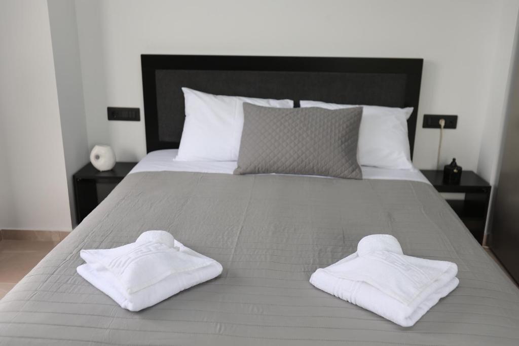 two white towels sitting on top of a bed at Luana Monte Apartments in Amoudara Herakliou