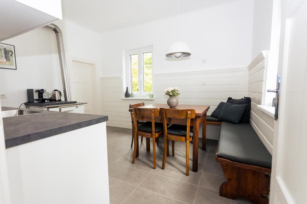 a kitchen and dining room with a table and chairs at Haus Roserlheim in Pörtschach am Wörthersee