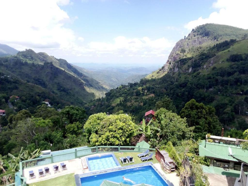 a house with a swimming pool in the mountains at Ravana Range Ella in Ella