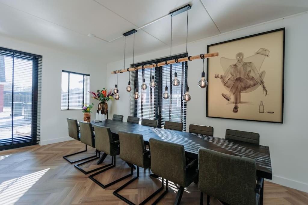 a dining room with a long table and chairs at Bright & luxurious brand new villa in Amsterdam! in Amsterdam