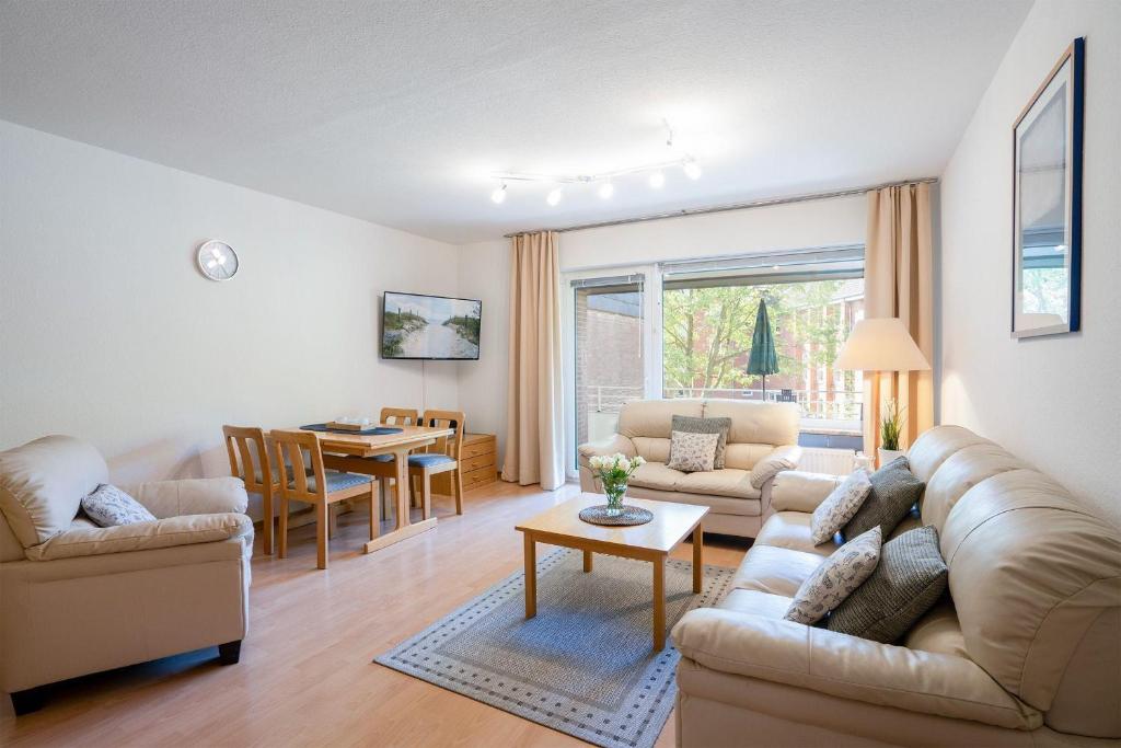 a living room with a couch and a table at AKH-044-Wellness-in-Haffkrug in Haffkrug