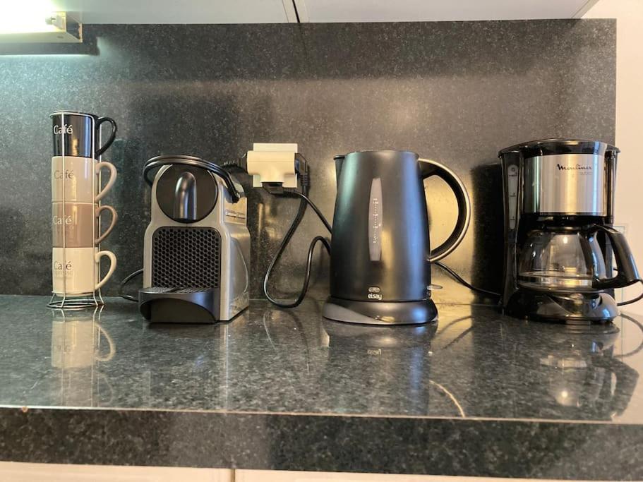 a group of appliances sitting on top of a counter at Appart Hypercentre Biarritz - PKG &#47; WIFI &#47; 4-6 Personnes in Biarritz