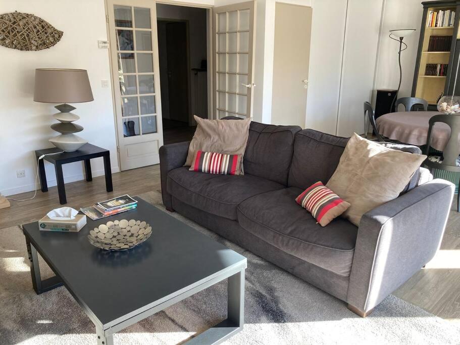 a living room with a couch and a coffee table at Appart Hypercentre Biarritz - PKG &#47; WIFI &#47; 4-6 Personnes in Biarritz