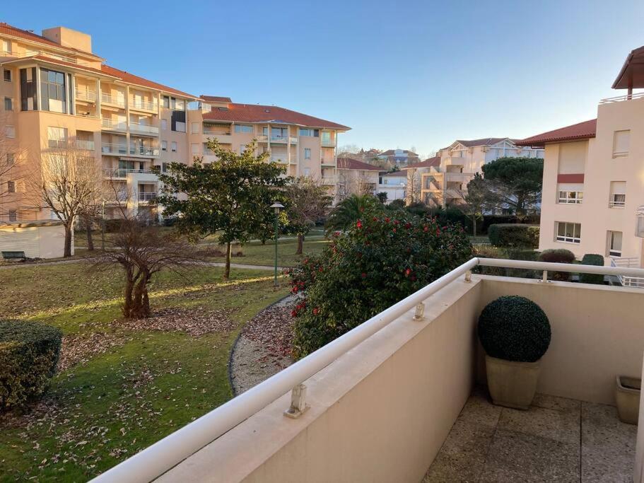 a balcony with a view of a park and buildings at Appart Hypercentre Biarritz - PKG &#47; WIFI &#47; 4-6 Personnes in Biarritz