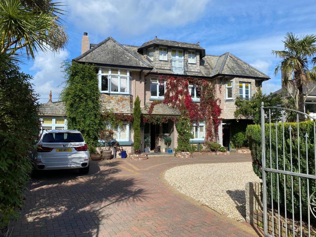 a car parked in front of a house at Bradleigh Lodge in St Austell