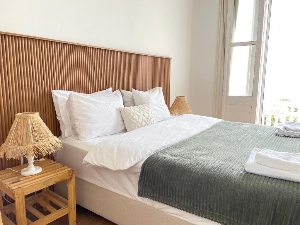 a bedroom with a large bed with a wooden headboard at Ikigai Hotel Villa Rıfat in Adalar