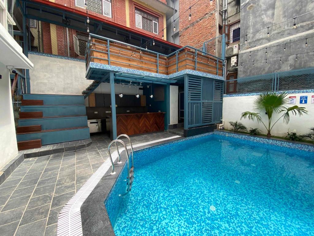 a swimming pool in the middle of a building at Alobar1000 Hostel in Kathmandu