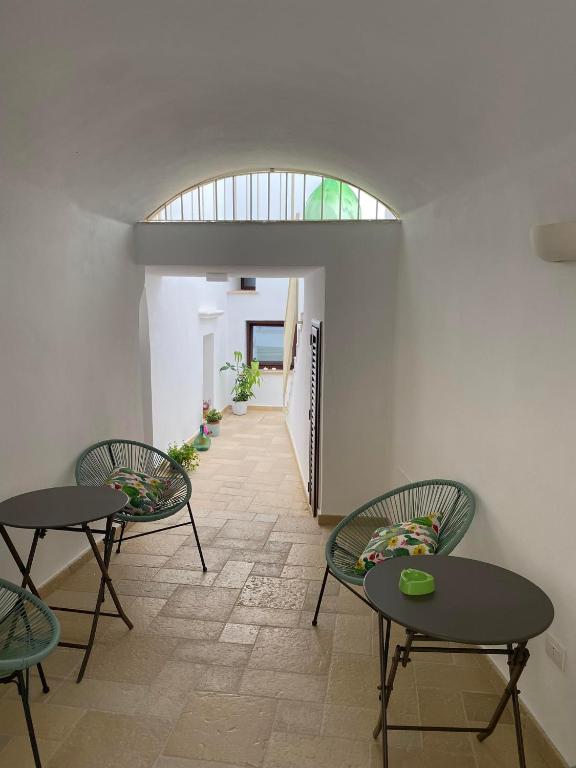 a room with two tables and two chairs and a hallway at Nonna Cia in Gallipoli