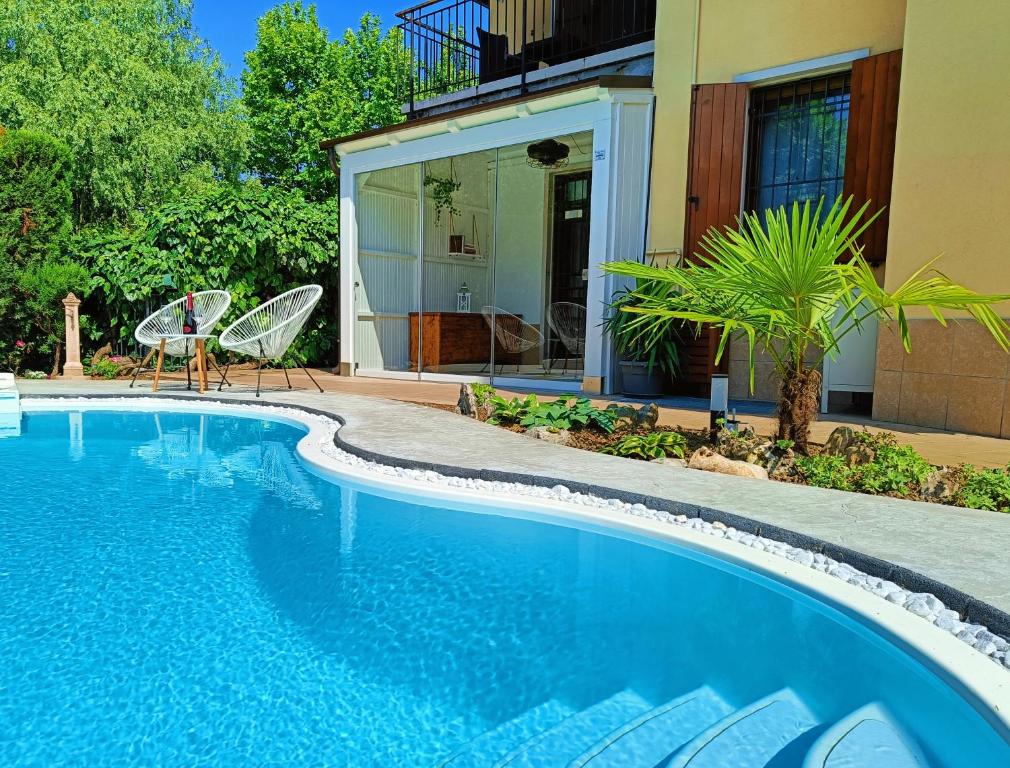 a swimming pool in front of a house at Picnic Room and Pool in Castelnuovo del Garda