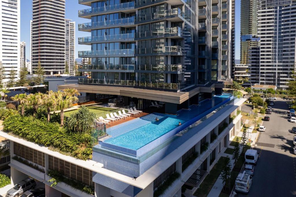 an aerial view of a building with a swimming pool at ULTIQA Signature at Broadbeach in Gold Coast