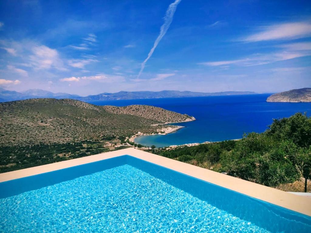 a swimming pool with a view of the water at Villa Kefali in Kavoúsion