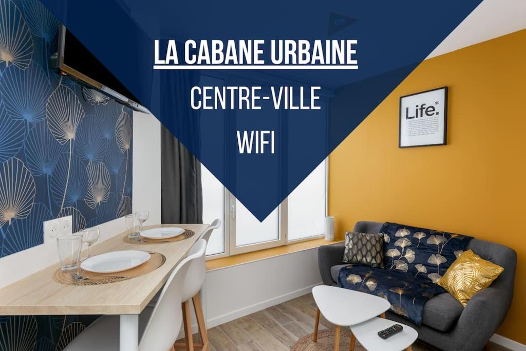 a living room with a table and a couch at La Cabane Urbaine in Brest