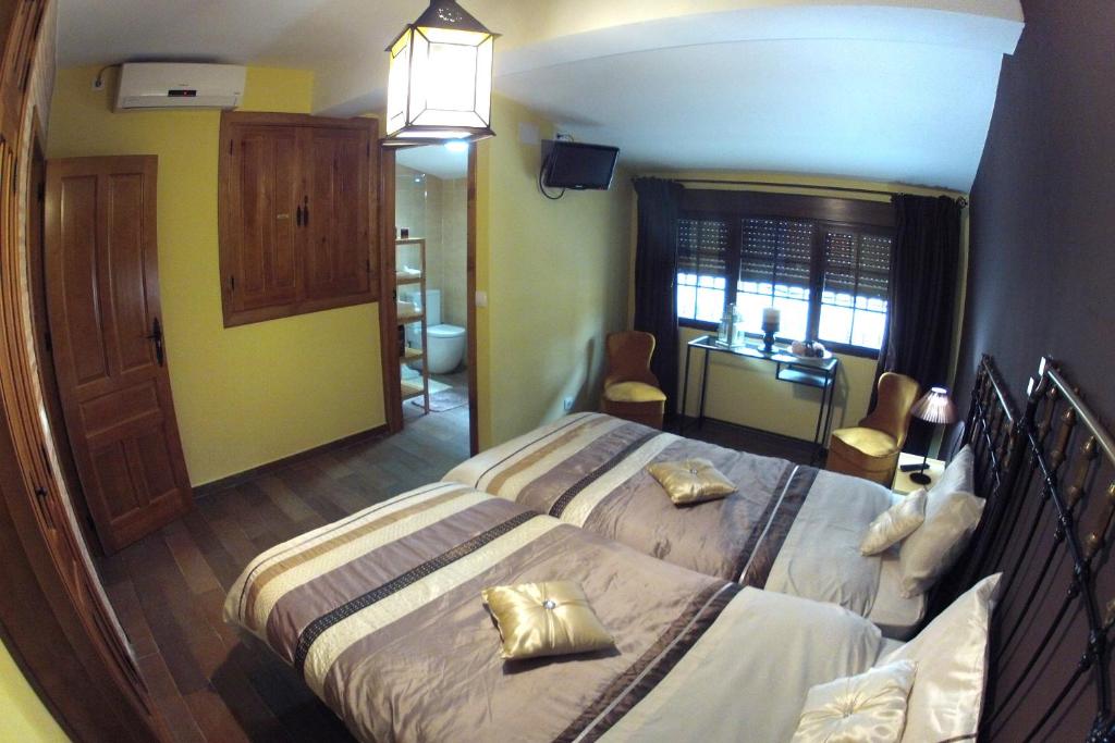 a hotel room with two beds and a desk at El Casino de Santa Cruz in Santa Cruz de la Sierra