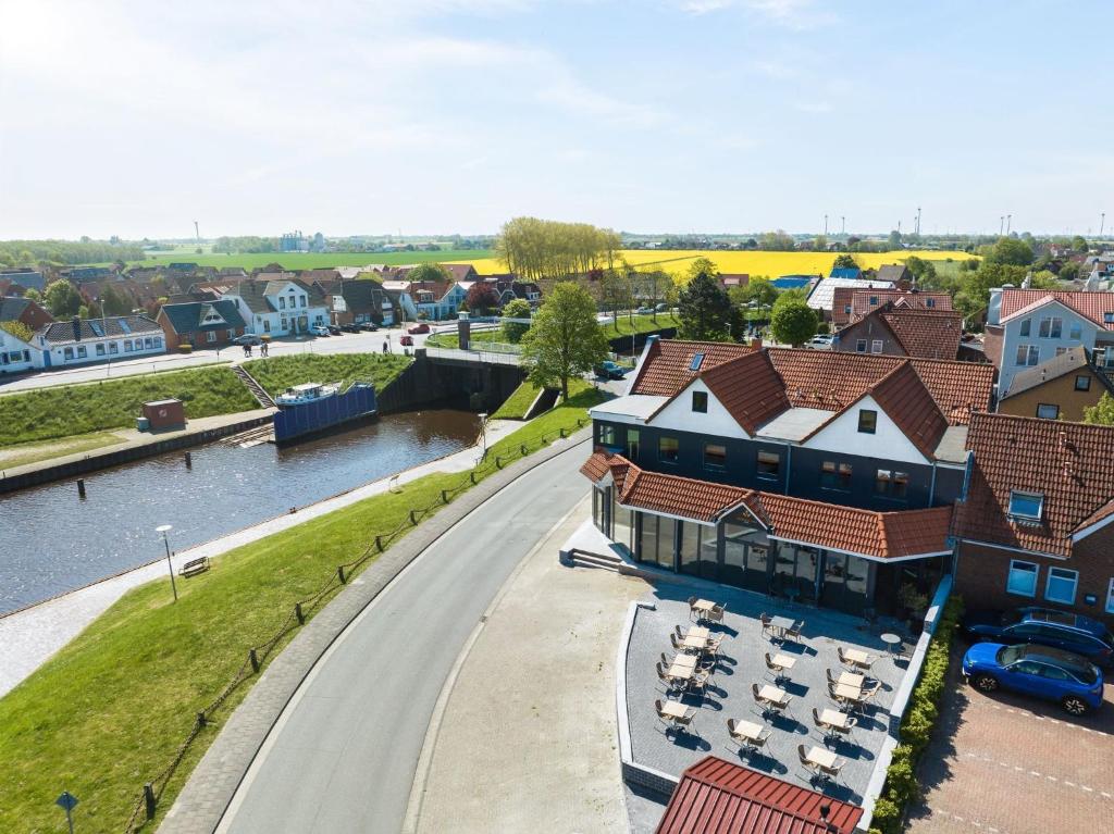 a view of a town with a river and buildings at Nordseehotel Tausendschön in Carolinensiel