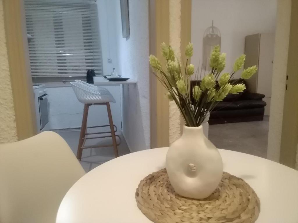 a white vase sitting on top of a table at President Guest House in Keratokampos