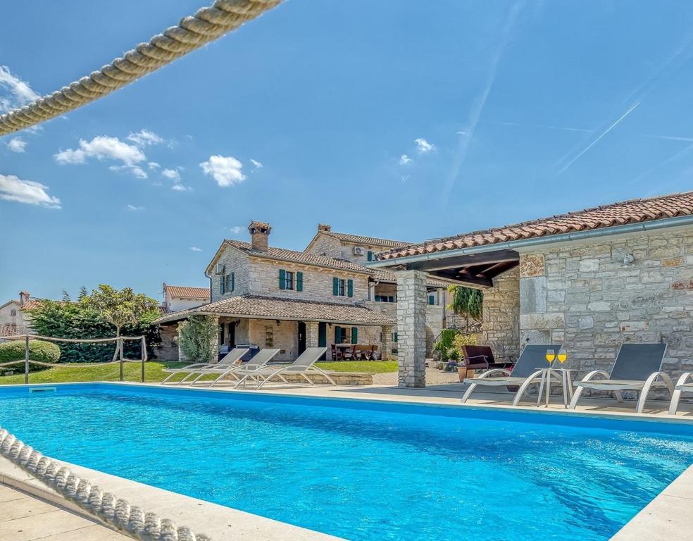 a swimming pool in front of a house at Villa Luna in Selina in Selina