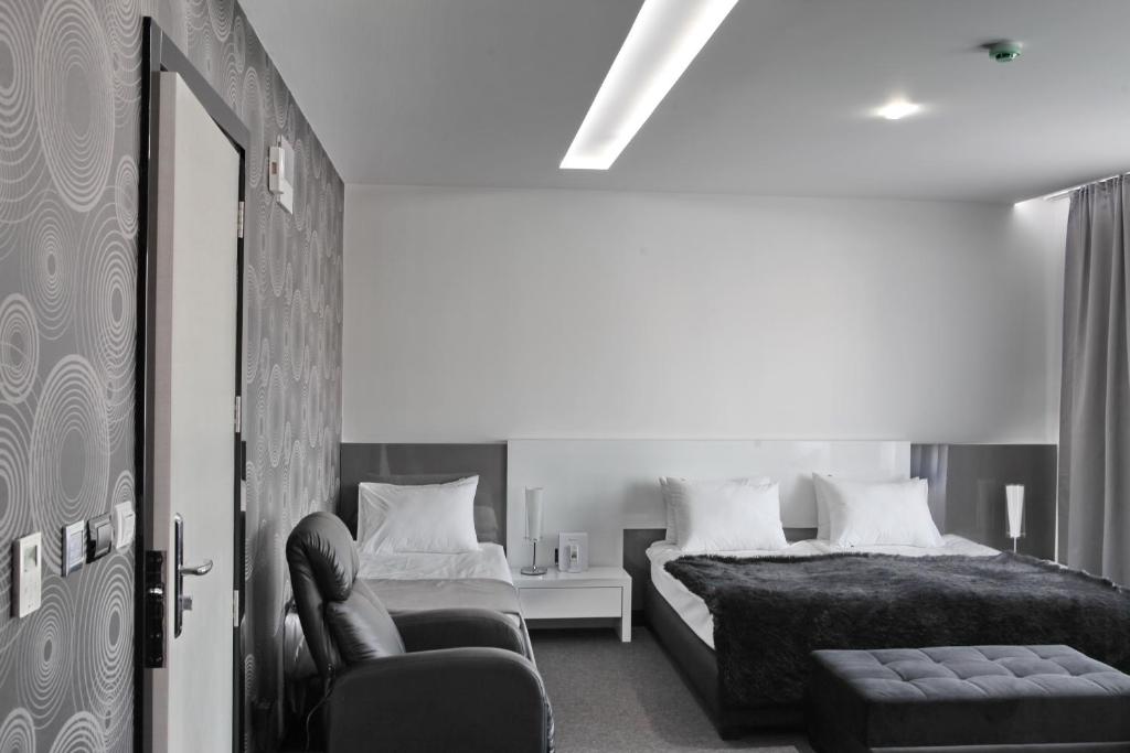 Postel nebo postele na pokoji v ubytování Nova City Garni Hotel Signature Collection