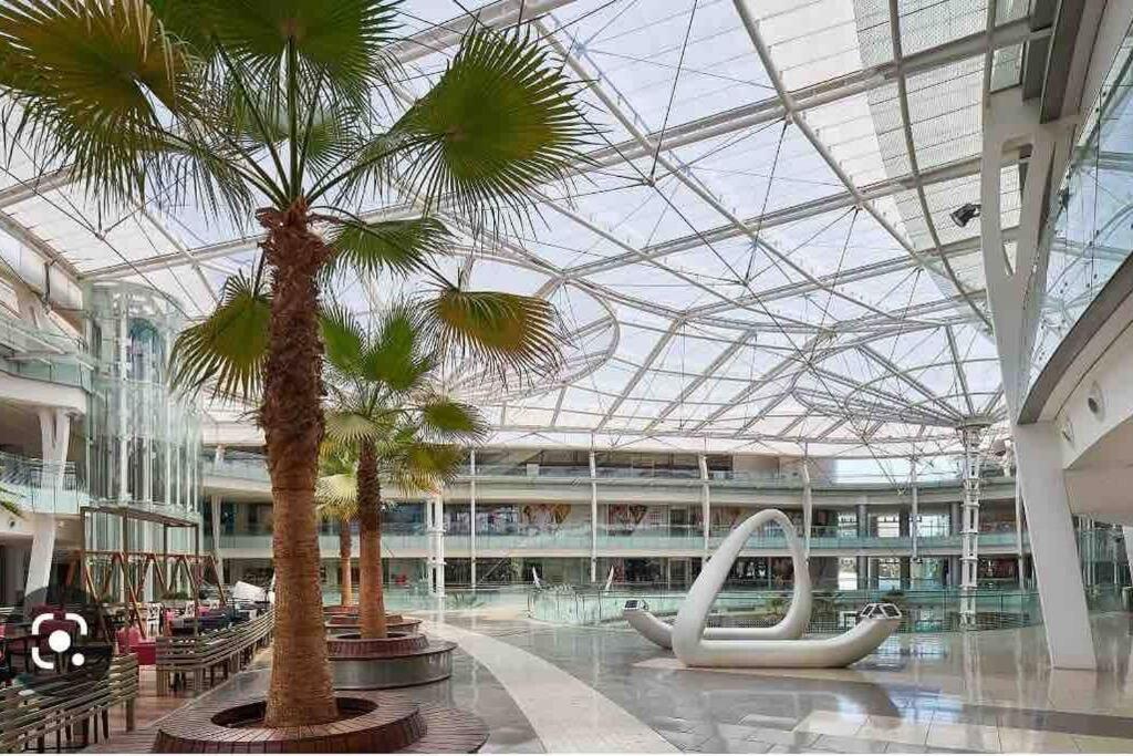 a large building with palm trees and a large ceiling at Modern studio in the heart of Amman in Amman