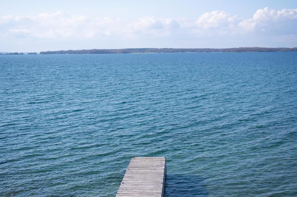 a dock in the middle of a large body of water at Fair Wind Motel and Cottages in Clayton
