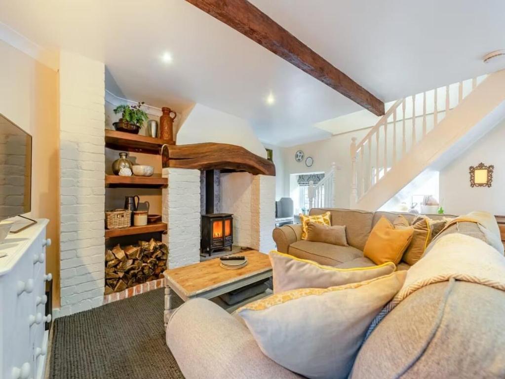 a living room with a couch and a fireplace at The Stable, Cuffern Manor Cottages in Haverfordwest