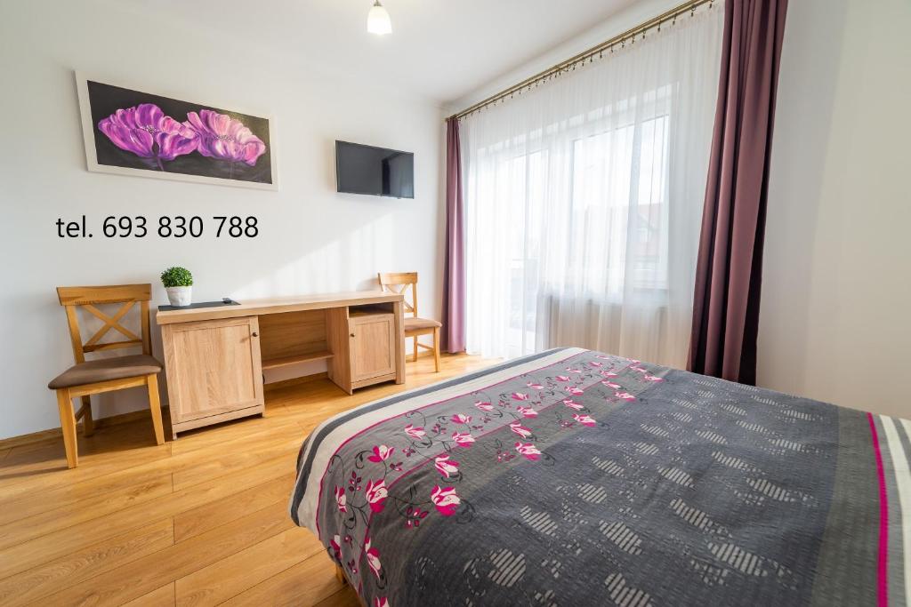 Posteľ alebo postele v izbe v ubytovaní Villa Mikołajki Popiełuszki 8