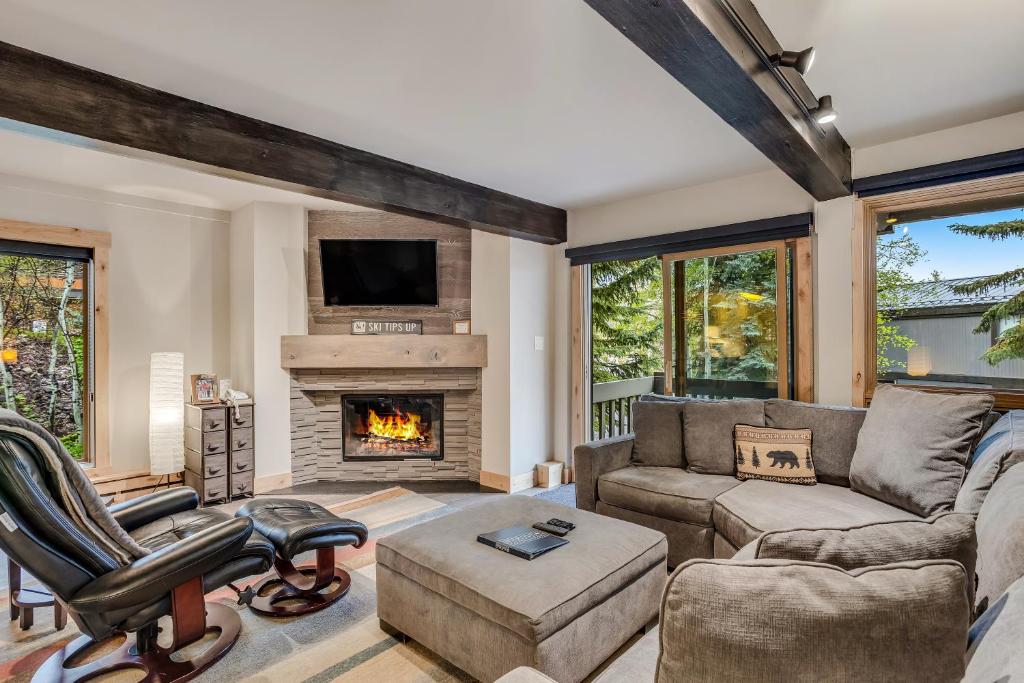 a living room with a couch and a fireplace at Interlude Condominiums 2-Bedroom Unit 101 in Snowmass Village