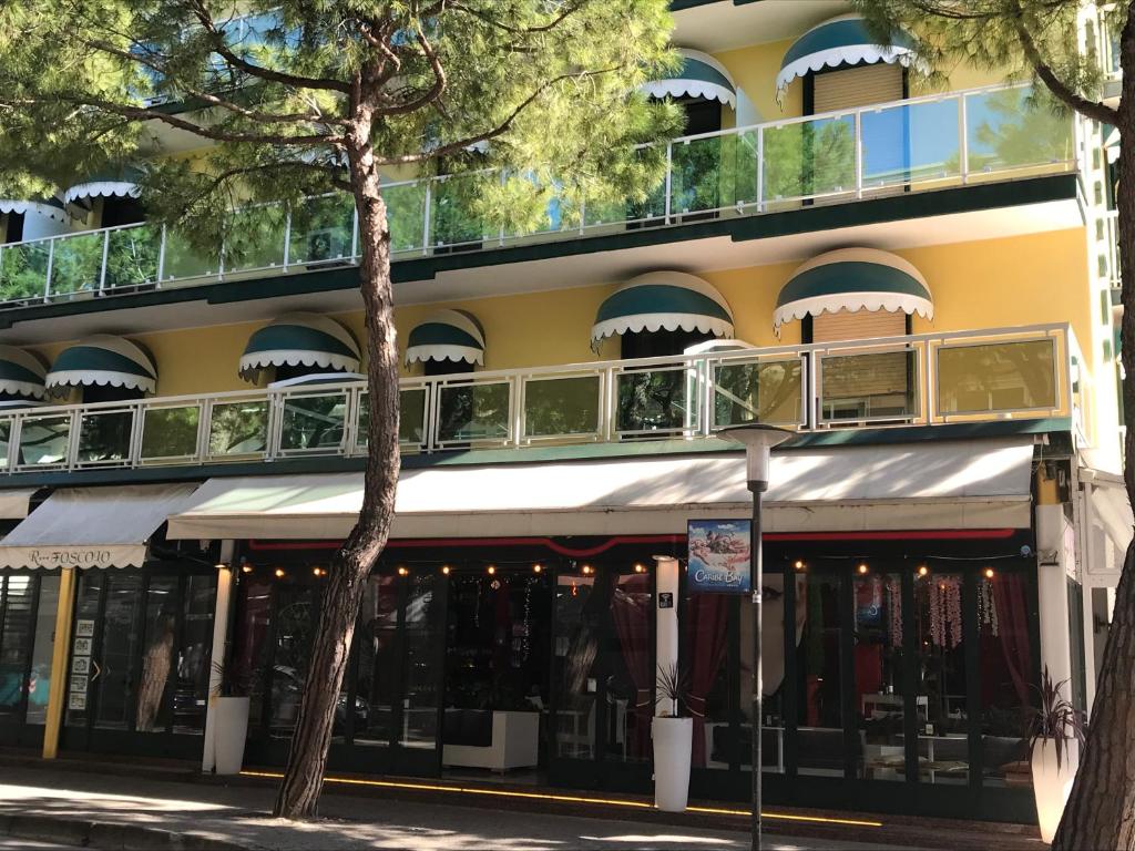 a building with balconies on the side of it at FOSCOLO Sunset House in Lido di Jesolo