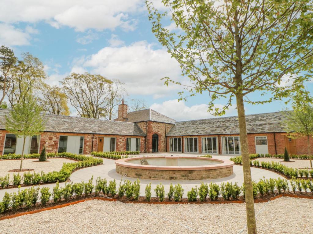 an exterior view of a building with a courtyard at Hilton Cottage in Appleby