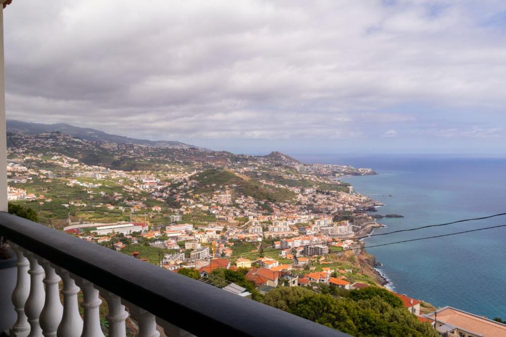 a view of the city of positano and the ocean at Sunset House in Câmara de Lobos