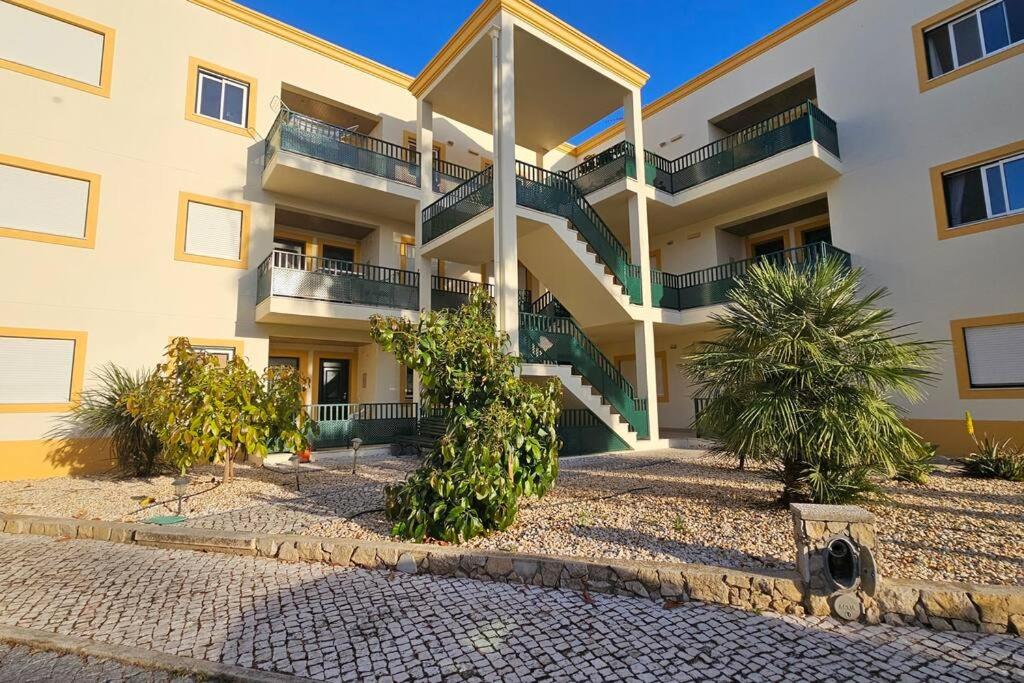 a building with stairs and trees in front of it at Holiday Apartment T2 Private Residence in Tavira