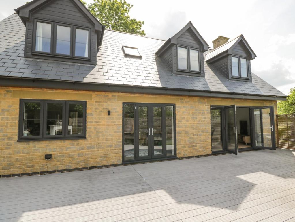a house with black windows and a grey roof at Greystones in Gloucester