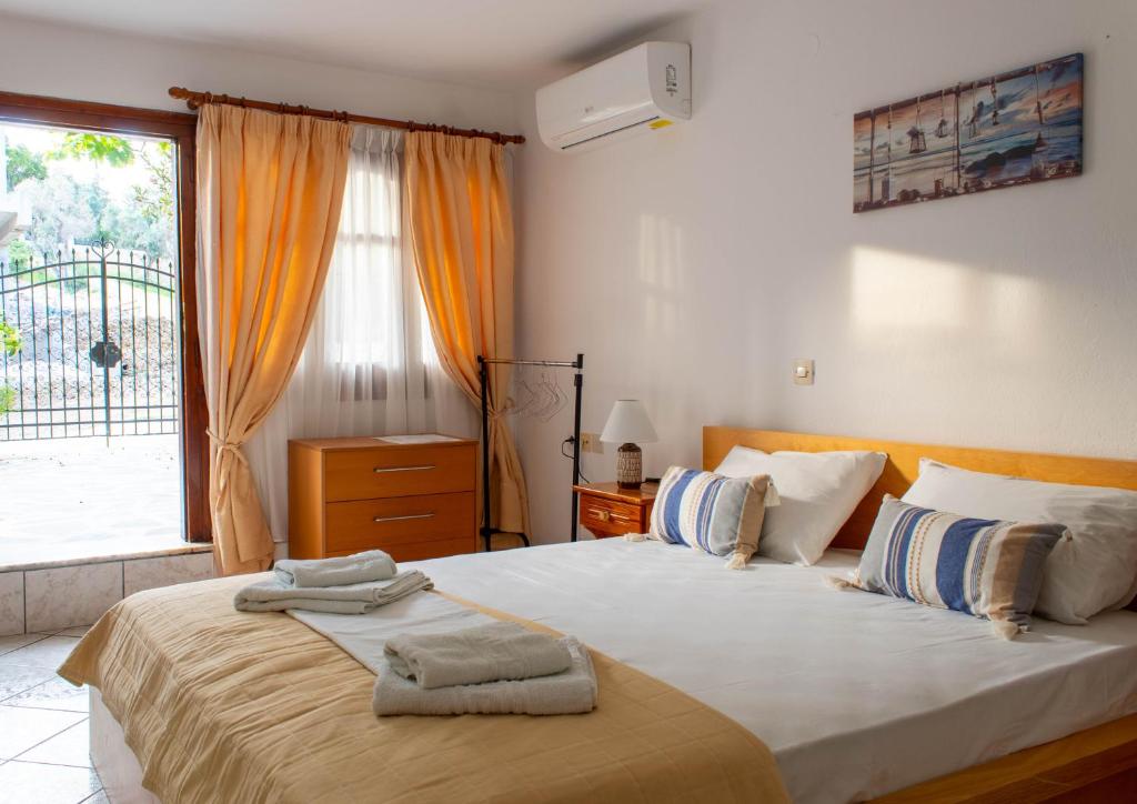 a bedroom with a large bed with towels on it at Alexandra's House in Skiathos