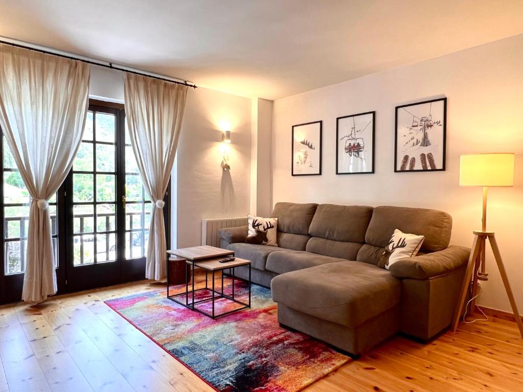 a living room with a couch and a table at Apartament Les 3 Valls in Llavorsí