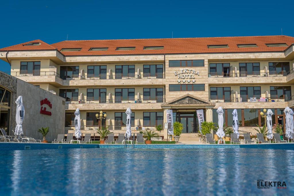 a hotel with a swimming pool in front of it at Elektra Vama Veche in Vama Veche