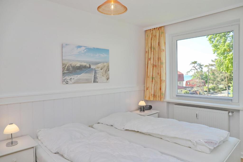 Postel nebo postele na pokoji v ubytování Strandschloss App 39