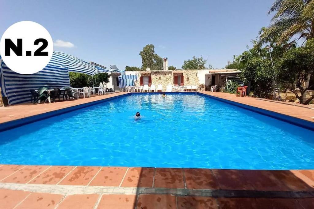 eine Villa mit einem Pool in einem Resort in der Unterkunft Casa N.2 + piscina e palestra [1O km da Gallipoli] in Tuglie