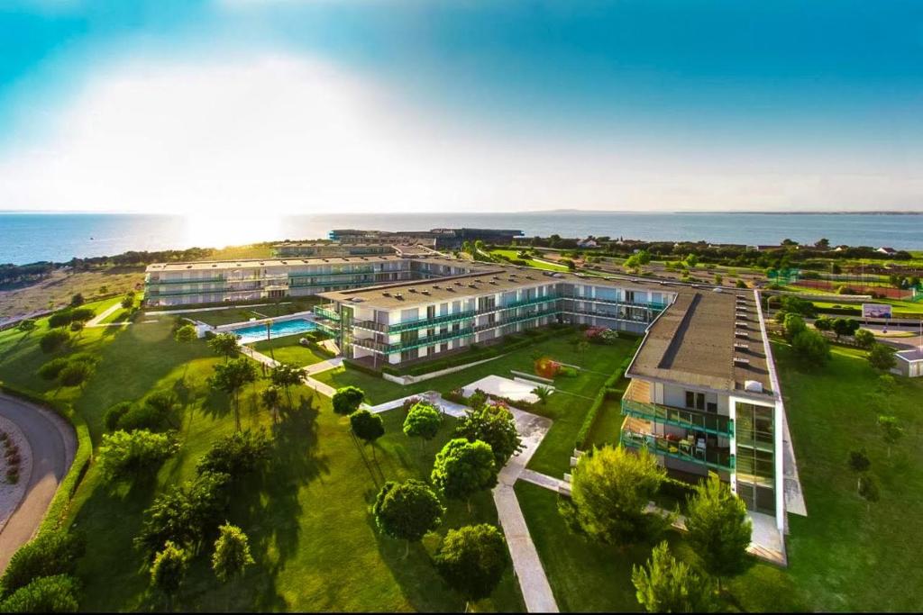 an aerial view of a building near the ocean at Premium Apartment Falkensteiner in Petrcane