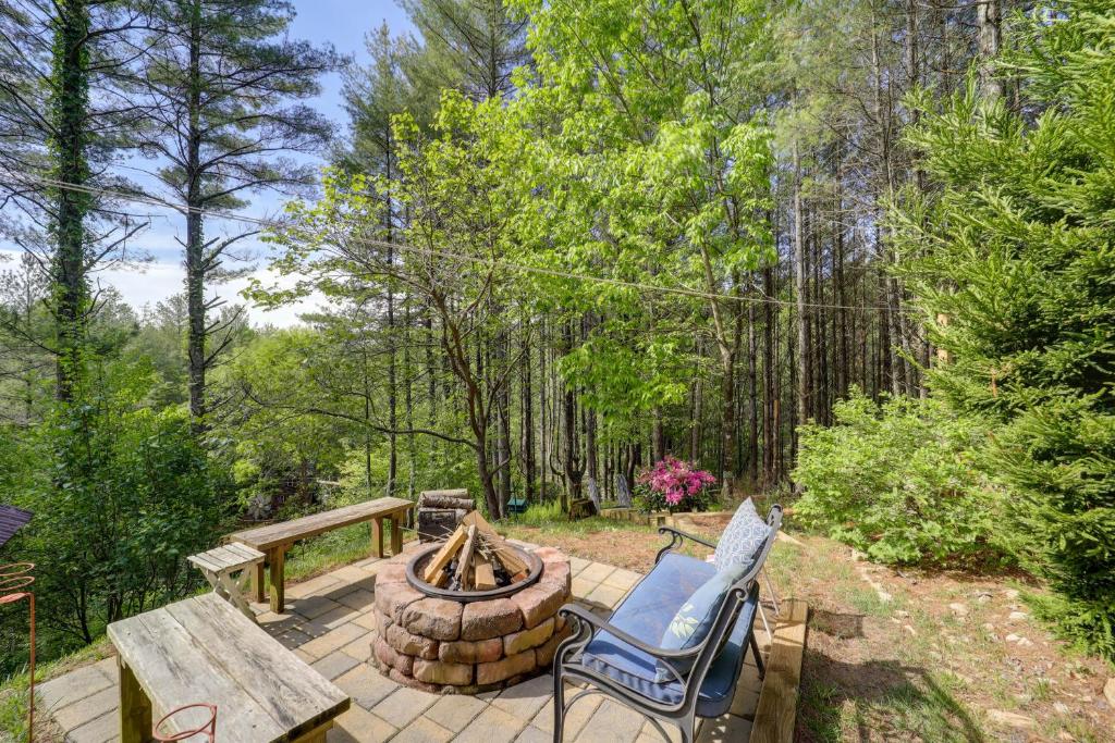 a patio with a fire pit and two chairs at West Jefferson Vacation Rental Near River in West Jefferson