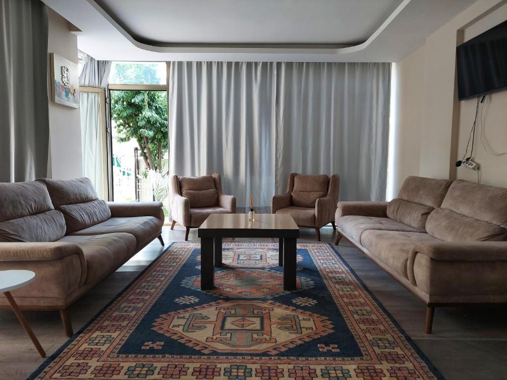 a living room with a couch and a coffee table at MY Garden View in Antalya