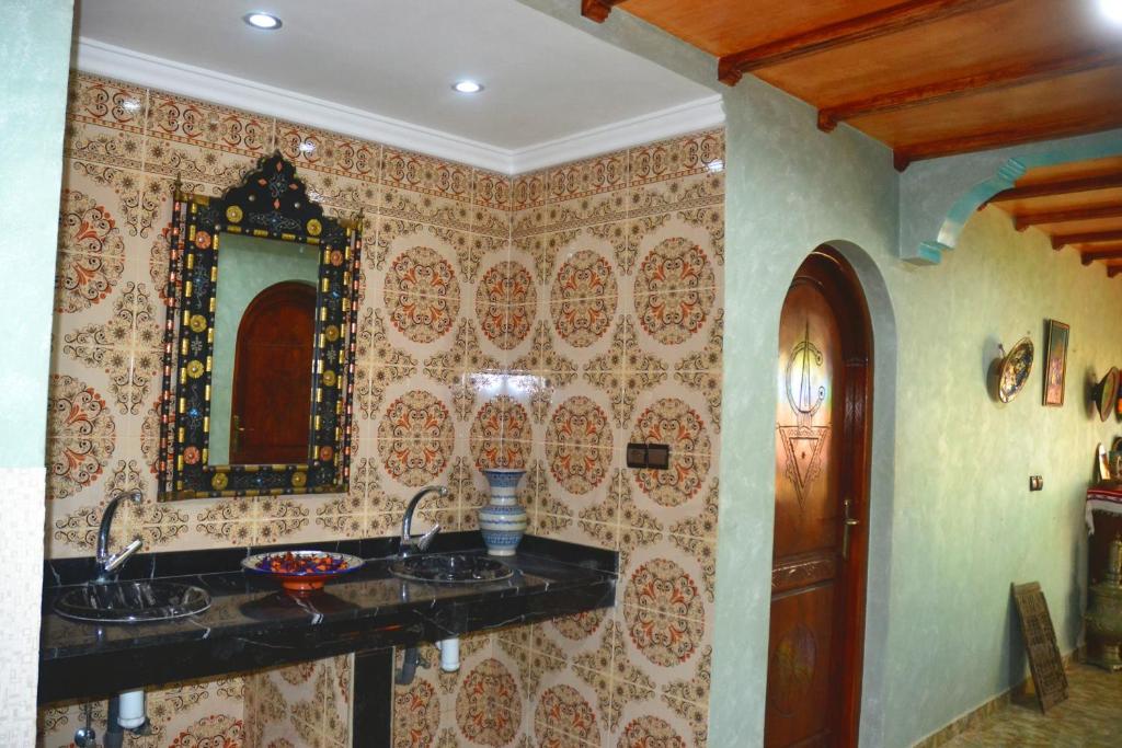 uma casa de banho com 2 lavatórios e um espelho em The Sunrise Villa em Agadir