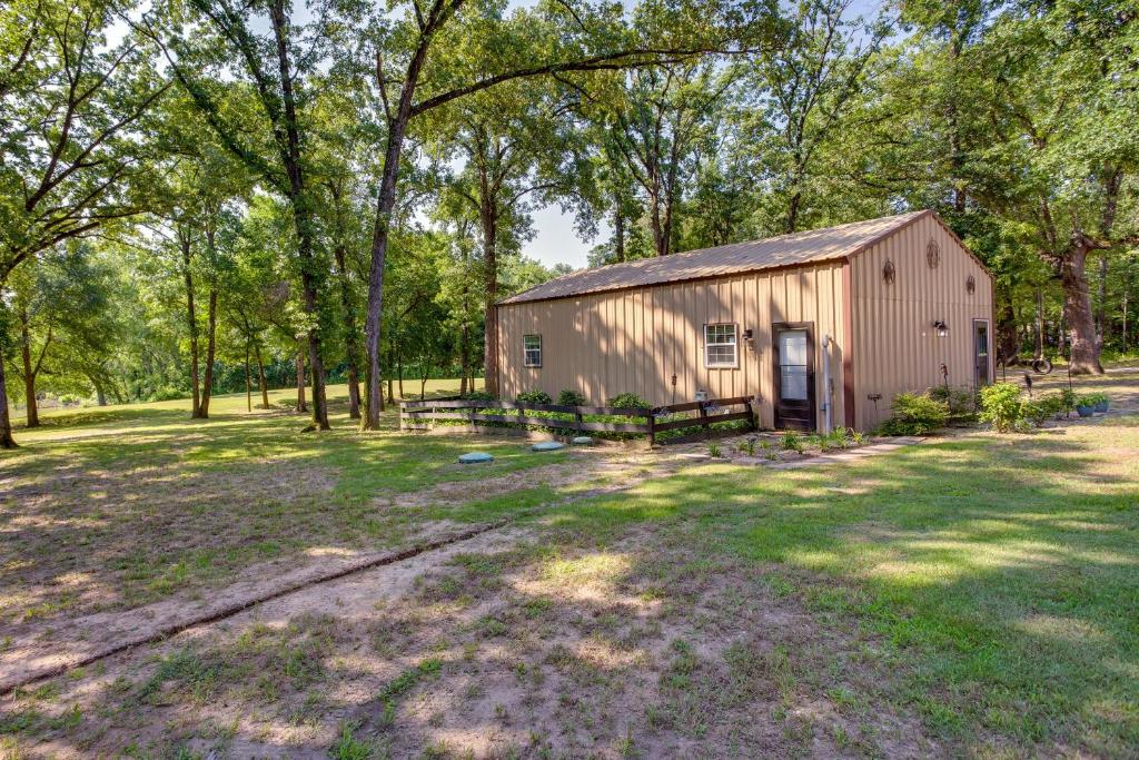 a barn in the middle of a field with trees at Lake Tawakoni Vacation Rental with Dock and Fire Pit! in Wills Point