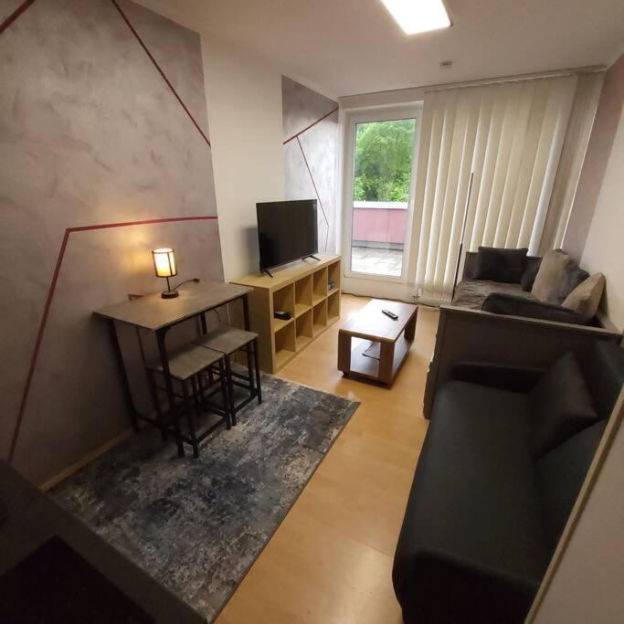 een woonkamer met een bank en een tafel bij Entspannen in Passau an der Donau inklusive Netflix in Passau
