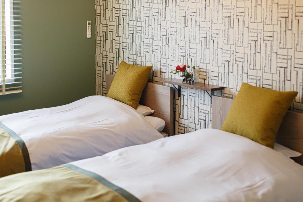 En eller flere senge i et værelse på PINO te COLO - Vacation STAY 38981v