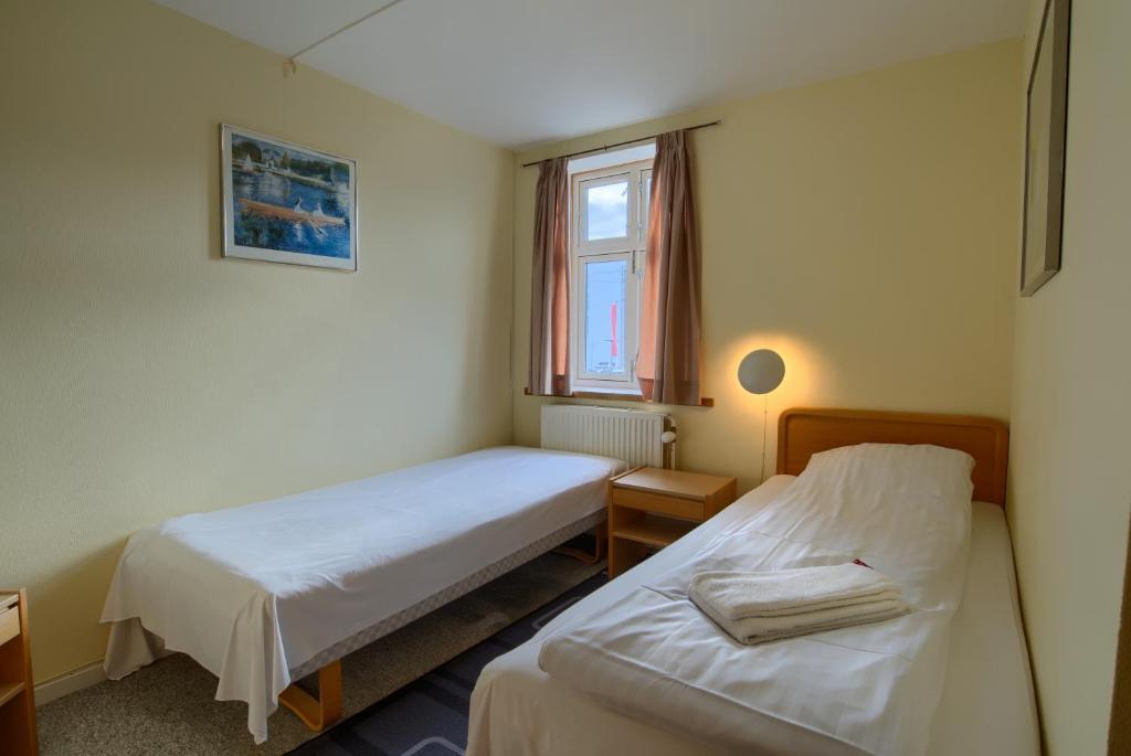 Postel nebo postele na pokoji v ubytování Ebsens Hotel