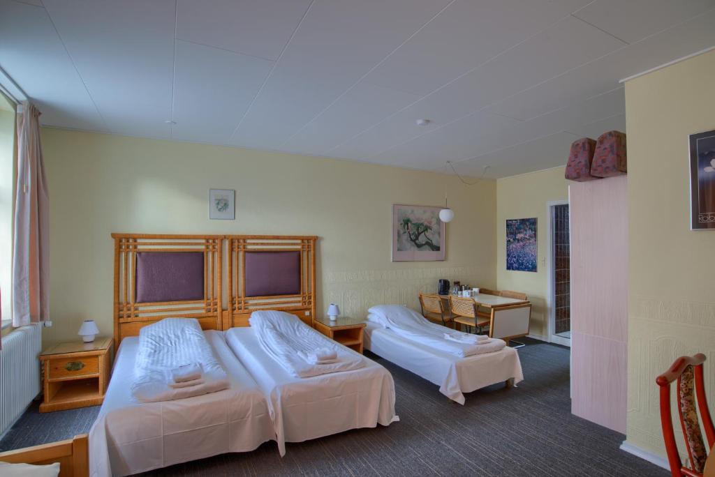Postel nebo postele na pokoji v ubytování Ebsens Hotel